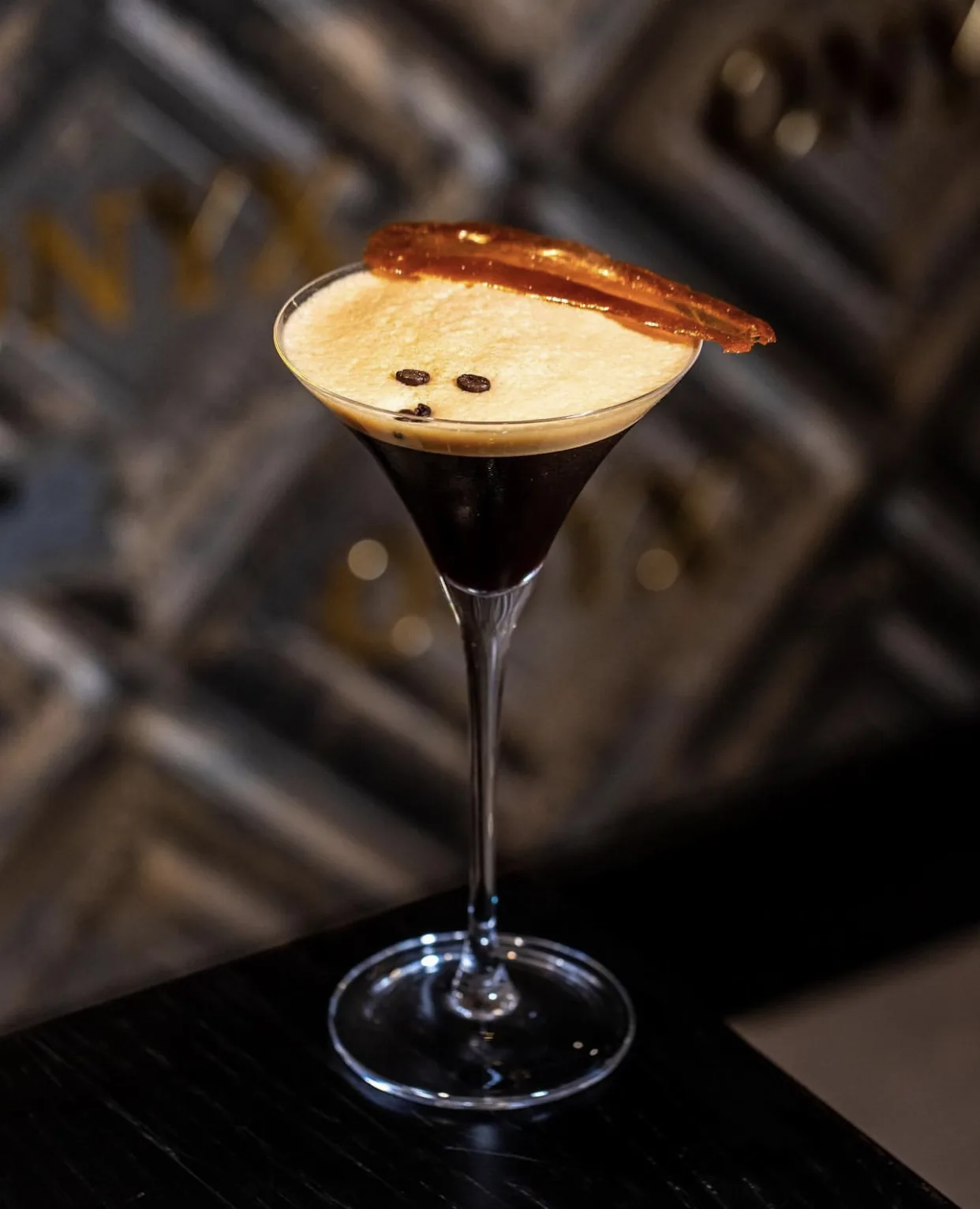 Espresso martini in front of Onyx wall texture