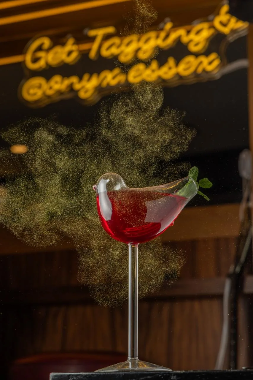 Red cocktail with glowing Onyx sign
